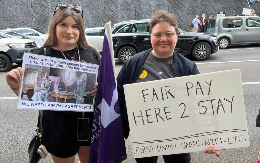 Zoe Port and Justine Sachs  protest against the repeal of Fair Pay Agreements outside the ACT Party headquarters in Auckland.