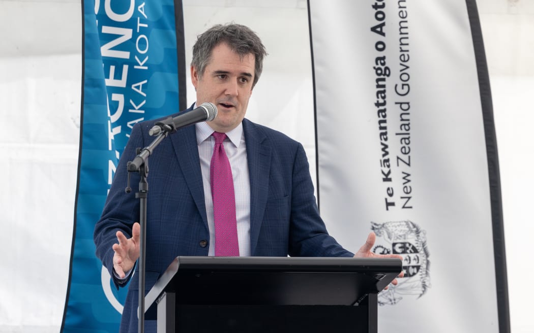 Housing Minister Chris Bishop at lectern