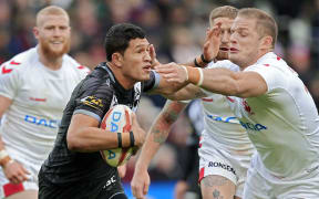 Englands George Burgess attempts to tackle New Zealands Dallin Watene-Zelezniak.