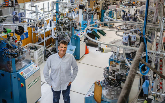 Norsewear owner Tim Deane stands between his sock-making mahcines at the factory in Norsewood, at the foot of the Ruahine ranges in southern Hawke’s Bay.