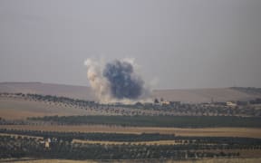 The photo taken from Karkamis district of the Turkey's Gaziantep province shows smoke rising as the Turkish fighter jets bomb Daesh targets in Jarabulus, Syria on August 24, 2016.