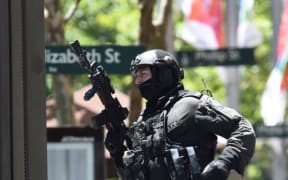 An armed officer outside the Lindt cafe during the 2014 Sydney seige.