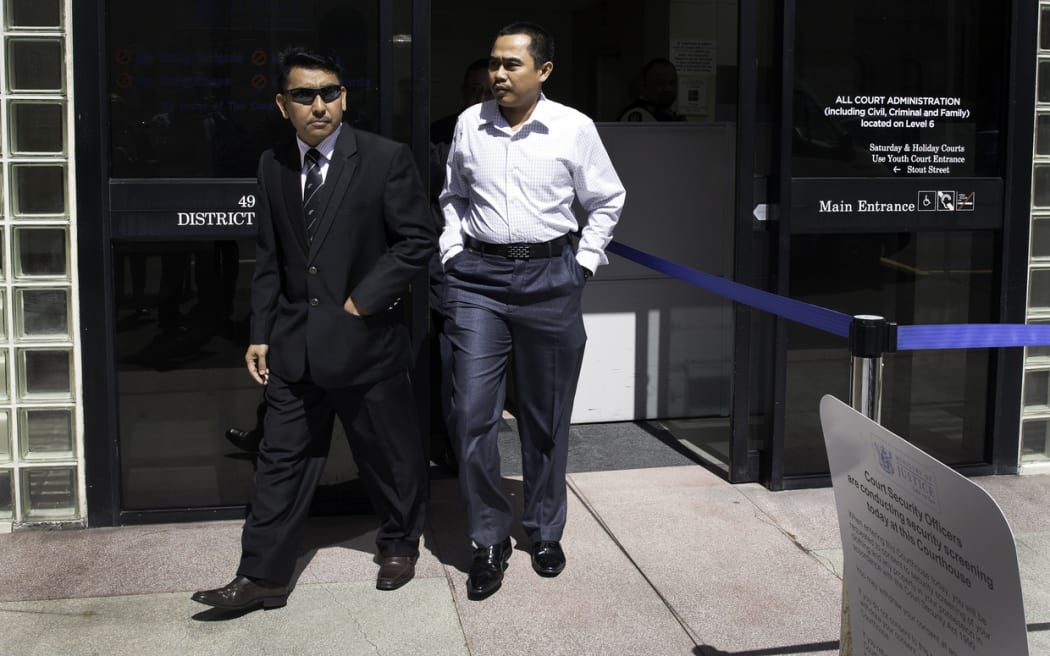 Muhammad Rizalman (right) coming out of the Wellington District Court.