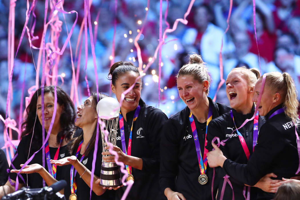 Maria Folau holds the World Championship Trophy as the team celebrate winning the Netball World Cup with a 52-51 victory over Australia in the final.