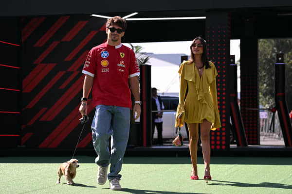 Ferrari's Monegasque driver Charles Leclerc arrives at the paddock accompanied by his girlfriend, Alexandra Saint Mleux, and his dog before the third practice session of the Mexico City Formula One Grand Prix at the Hermanos Rodriguez racetrack in Mexico City on October 25, 2025. (Photo by Yuri CORTEZ / AFP)