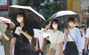 Tokyo residents were warned about the risk of heat stroke while wearing masks during a heatwave in June.