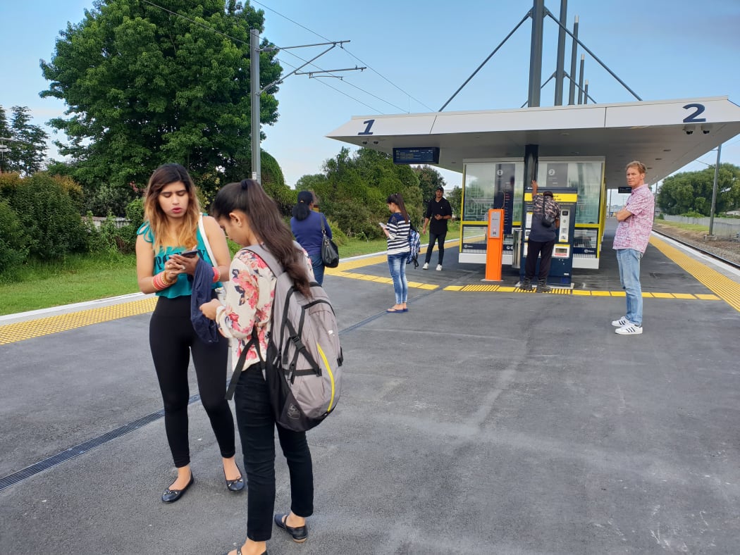 Stranded passengers await for updates on the train situation at Takanini train station.