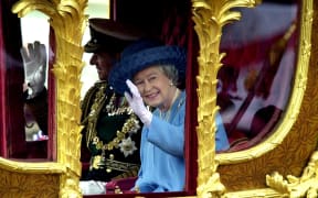 Britain's Queen Elizabeth II waves to the crowd as she rides 04 June 2002 in the Gold State coach from Buckingham Palace to St Paul's Cathedral for a service of Thanksgiving to celebrate to her Golden Jubilee. The coach was built for King George III in 1762, and has only been used by the Queen twice before -- for her Coronation, and her Silver Jubilee.