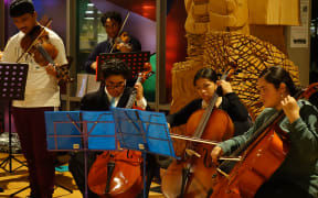 Some of the Virtuoso Strings members performing at the opening of a photo exhibition on the orchestra.