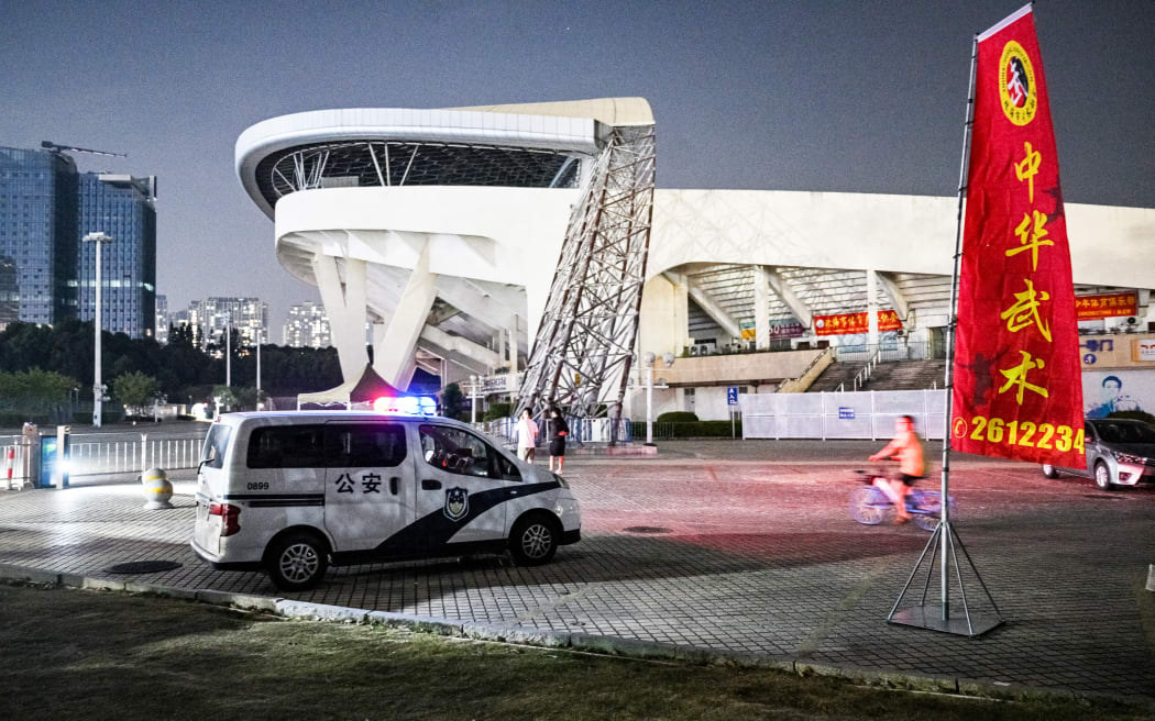 A police car is seen at the Zhuhai Sports Centre, a day after a car rammed through the site killing dozens in Zhuhai, in south China's Guangdong province on November 12, 2024. - A driver has killed 35 people and wounded 43 others in southern China, police said on November 12, a day after the car ploughed down people exercising in a sports centre in the city of Zhuhai (Photo by Hector RETAMAL / AFP)