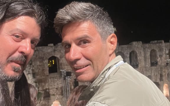 Vasili and friend watching the Xylouris family play at the ancient Odeon of Herodes Atticus