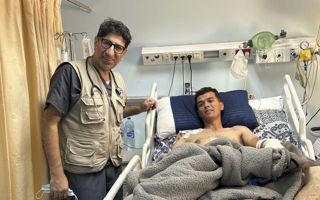 Dr. Ammar Ghanem, an ICU specialist from Detroit volunteering in one of Gaza's last functioning hospitals, stands by a young patient recovering from pneumonia on May 9, 2024, in Khan Younis, Gaza. A group of 35 foreign doctors on a volunteer mission to help at the hospital, including 22 Americans, have been trapped in Gaza by Israel’s seizure of the Rafah crossing into Egypt.