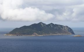 An aerial file photo shows Okinoshima, located in Genkai-nada Sea, in Munakata City, Fukuoka Prefecture onSep.5, 2015. The sacred island of Okinoshima and associated sites in the Munakata Region was added to UNeSCO World Heritage list in July 2017. ( The Yomiuri Shimbun ) (Photo by Hitomi Sadasue / The Yomiuri Shimbun via AFP)