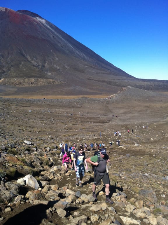 Crowds of people walk the Tongariro Crossing