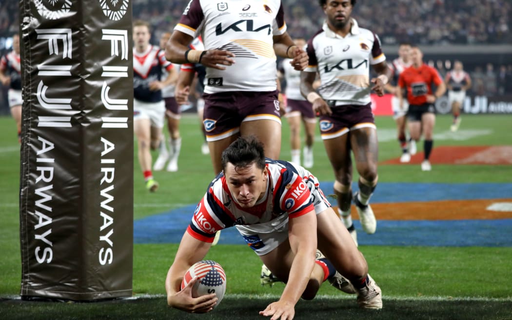 Joseph Manu of the Roosters scores a try.