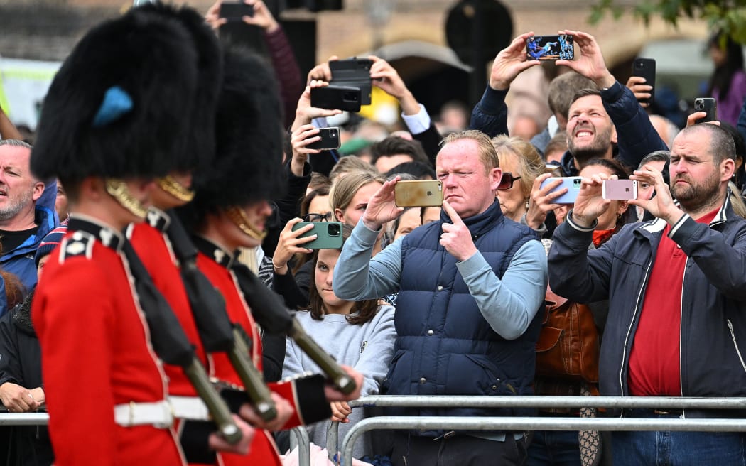 People take images of the guards during the State Funeral Service of Queen Elizabeth II in London on September 19, 2022.