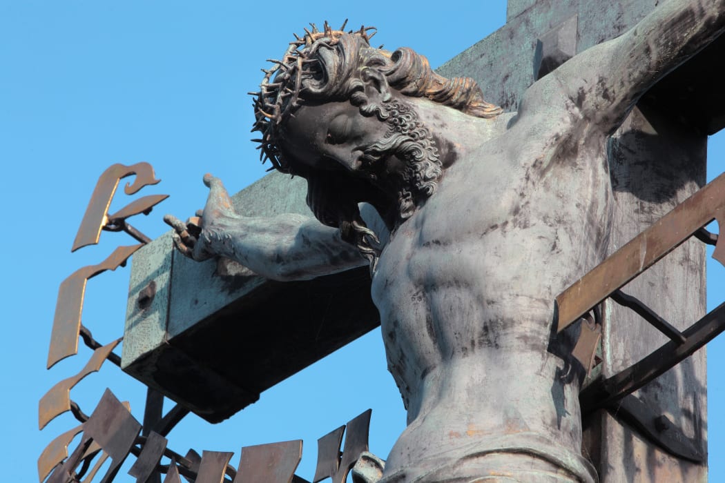 Detail of the Crucifix and Calvary sculpture, installed 1657, on the Charles Bridge or Karluv most over the Vltava river, Prague, Czech Republic. Bought in Dresden, this crucifix was originally made in 1629 by H Hillger after a design by W E Brohn.