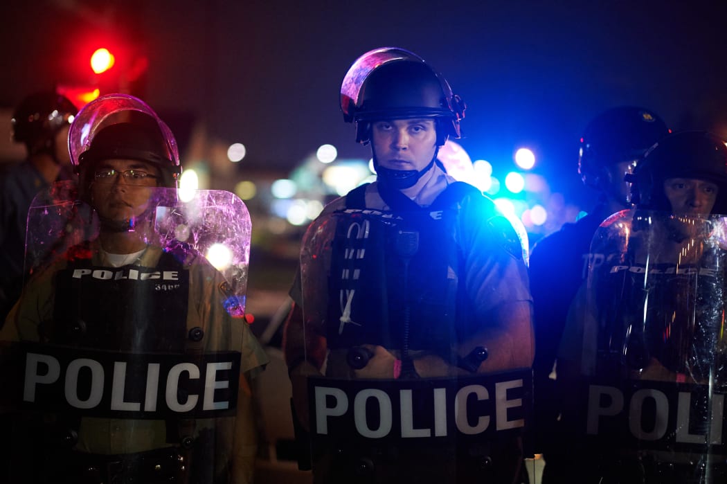 St Louis County Police and Missouri State Highway Patrol troopers stand on guard during the demonstration.