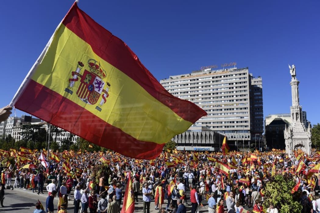 Protesters gather holding Spanish flags during a demonstration against independence of Catalonia.