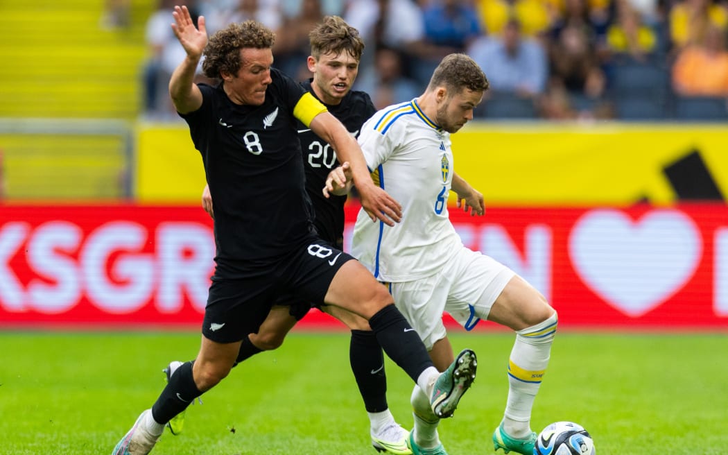 Joe Bell of New Zealand and Gabriel Gudmundsson of Sweden contest possession during their international friendly in Stockholm.