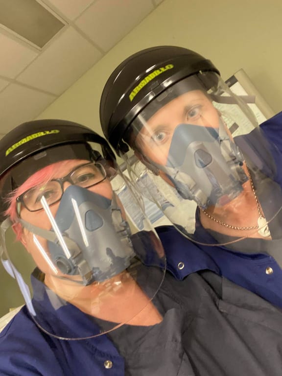 Nurse Abbey Vanderschantz (left) and colleague dressed in PPE