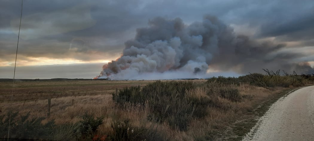 Smoke from a fire burning through 1000 hectares of manuka scrub and peat soils at Awarua, south of Invercargill, on 3 April, 2022.