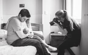 Emma, photographing baby Jasmine.
