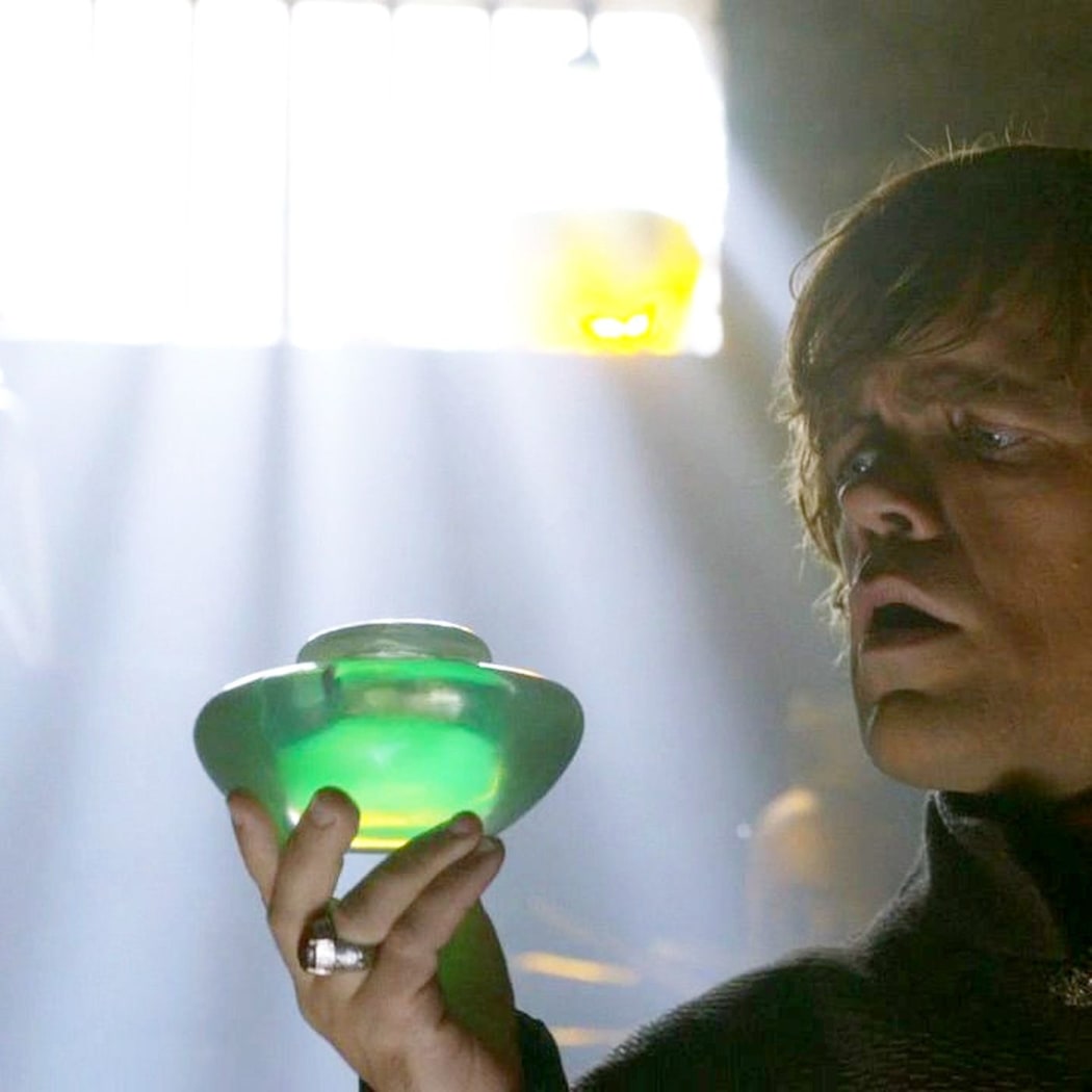Tyrion Lanister (Peter Dinklage) holding jar of wildfire.