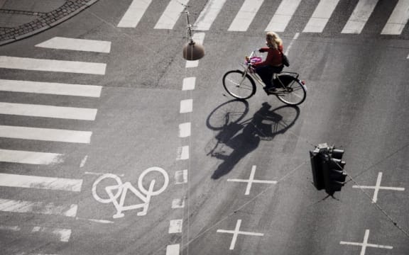 Girl on bicycle at crossroads, Copenhagen, Denmark, Scandinavia, Europe (Photo by Purcell-Holmes / Robert Harding Premium / robertharding via AFP)