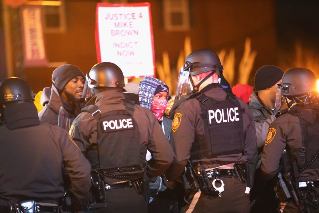 Police confront protestors in Ferguson after the shooting of Michael Brown in November.
