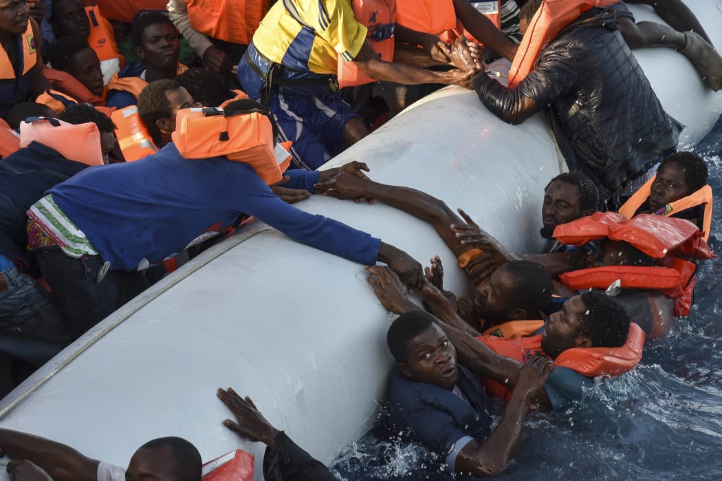 Migrants panic as they fall in the water during a rescue operation by the Topaz Responder ship, run by NGOs.