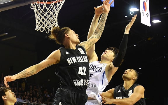 Tall Blacks forward Issac Fotu leaps for the ball against Korea.