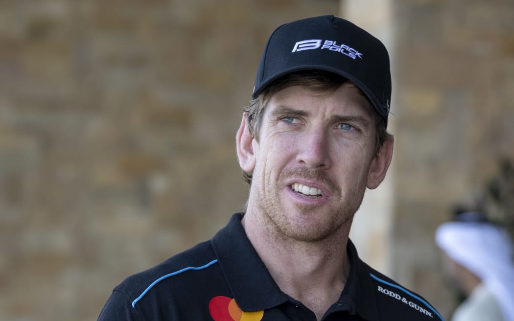 Peter Burling, co-CEO and driver of Black Foils SailGP Team looks on after sustaining a finger injury, Abu Dhabi, 2025.