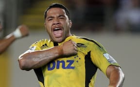 Hurricanes hooker Motu Matu'u celebrates scoring a try.