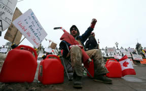 A man protests in front of the Parliament as demonstrators continue to protest the vaccine mandates on February 11, 2022 in Ottawa, Canada.