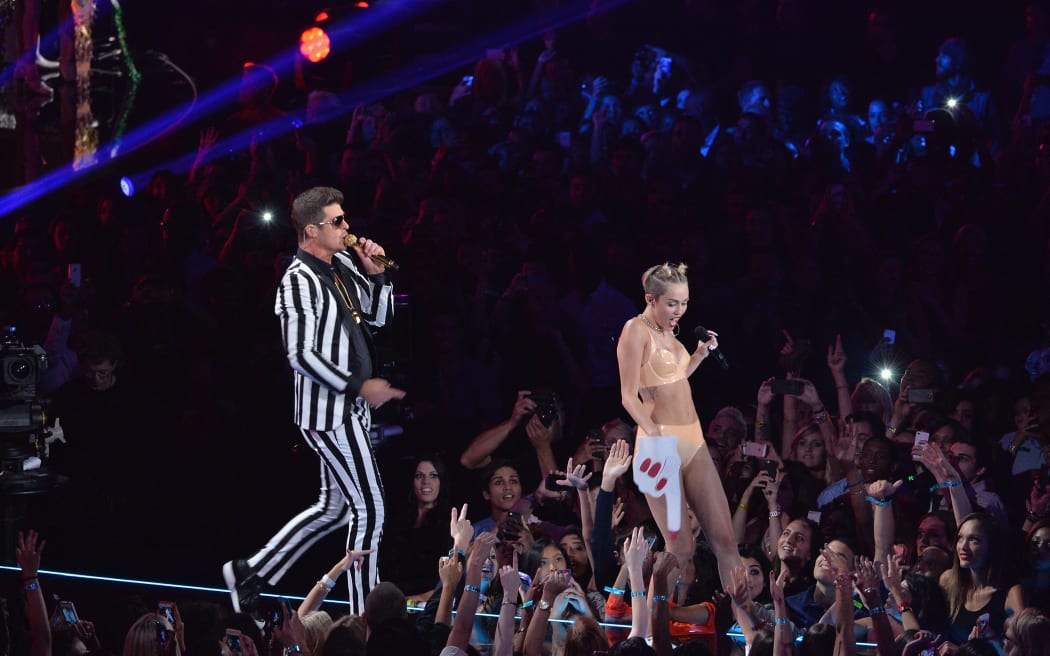 Robin Thicke and Miley Cyrus (R) perform onstage during the MTV Video Music Awards at the Barclays Center on August 25, 2013 in the Brooklyn borough of New York City.