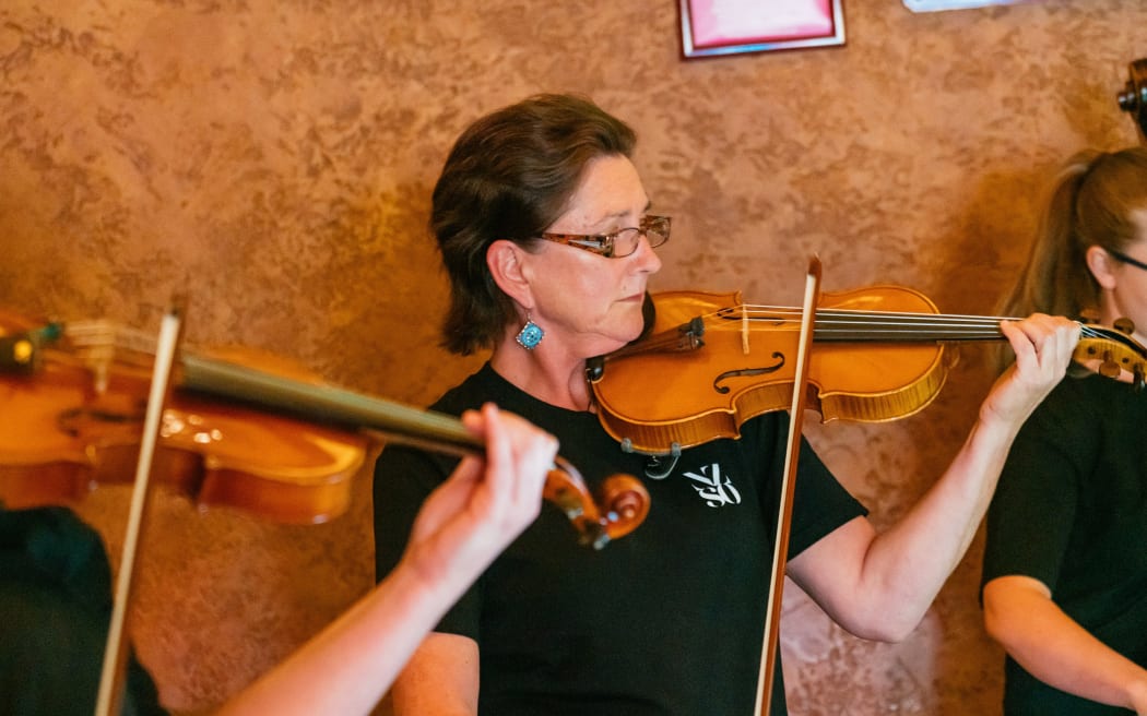 NZSO violinist Elizabeth Patchett playing her instrument.