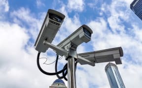 Many monitors produced by Hikvision, a Chinese manufacturer and the world's largest supplier of video surveillance products, are seen at local central business district with the landmark, Oriental Pearl Radio & Television Tower, as background, at the Bund, Shanghai, China, 28 November 2019. (Photo by Wang Gang / Imaginechina / Imaginechina via AFP)