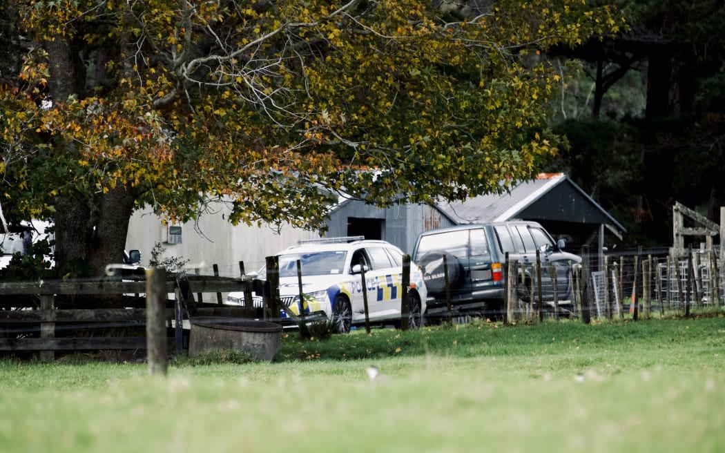 Police cars at a property on Anzac Valley Rd in rural Waitākere, west Auckland, on 18 April 2024.