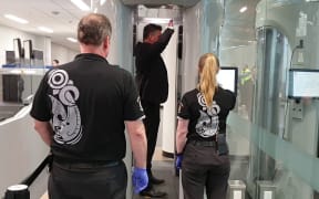 Dunedin Airport chief executive Richard Roberts testing out the new millimetre-wave technology body scanners at the airport.