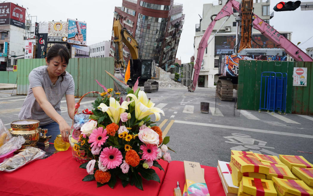 An altar is set to mourn a woman who died under a collapsed building before the start of demolition work in Hualien, eastern Taiwan on April 5, 2024. The magnitude 7.2 earthquake hit eastern Taiwan near Hualien on April 3rd.( The Yomiuri Shimbun ) (Photo by Ichiro Ohara / Yomiuri / The Yomiuri Shimbun via AFP)
