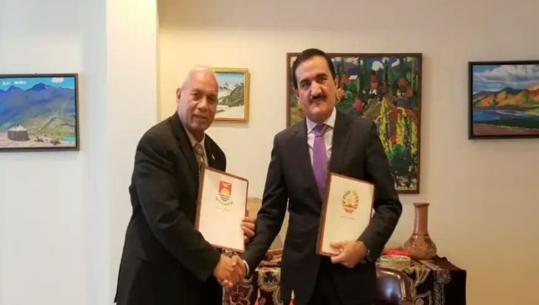 Kiribati former president Teburoro Tito (left) and Tajikistan's Mahmadamin Mahmadaminov shortly after the signing.