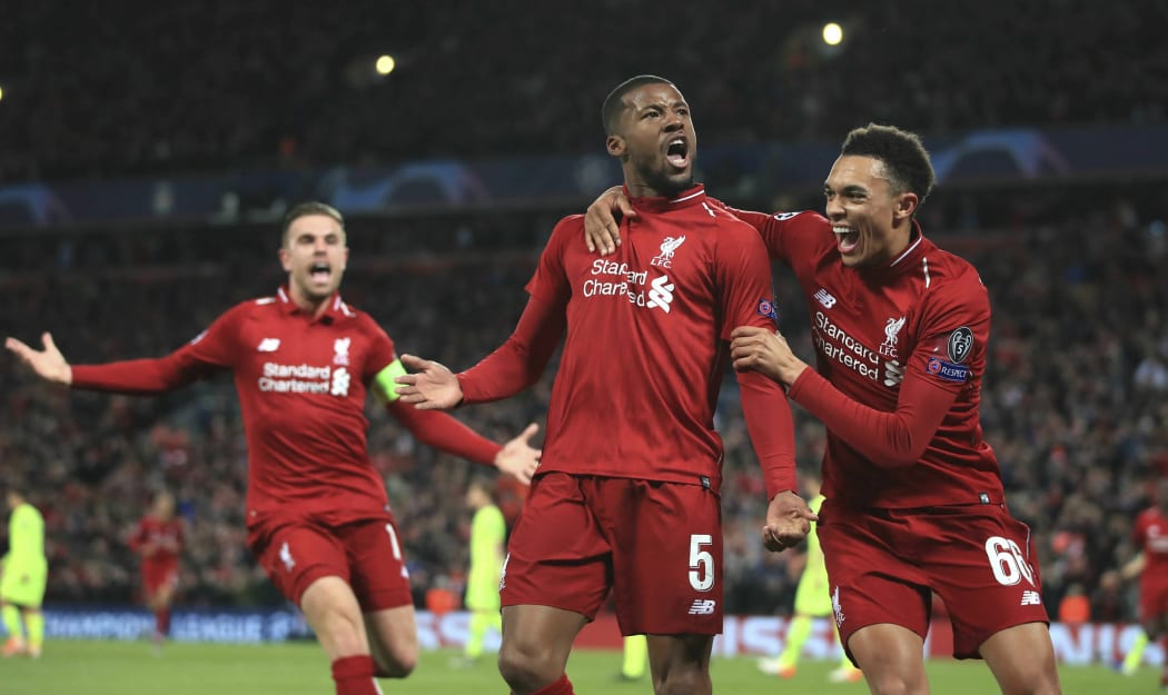Liverpool's Georginio Wijnaldum, center, celebrates scoring his side's third goal during the Champions League semi final between Liverpool and Barcelona at Anfield.