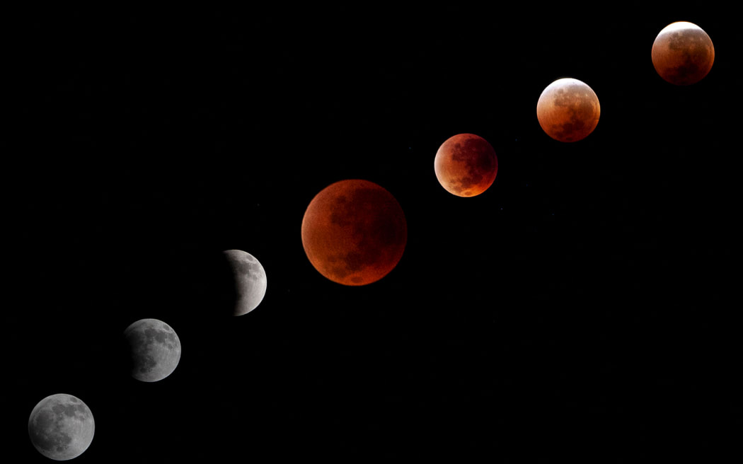 A montage of pictures shows the phases of the Blood Moon Total Lunar Eclipse as it is seen in Depok City, West Java province, Indonesia, on September 8, 2025. (Photo by Aditya Irawan/NurPhoto) (Photo by Aditya Irawan / NurPhoto via AFP)