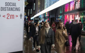 Shoppers walk along Oxford Street after new coronavirus restrictions were announced by British Prime Minister Boris Johnson.