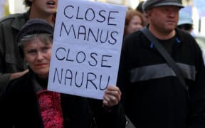 Street marcher with sign calling for closure of Nauru and Manus island detention center during World Refugee Rally June 20, 2015 in Brisbane, Australia.