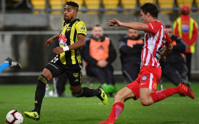 Phoenix striker Roy Krishna eludes Melbourne City defender Curtis Good.
