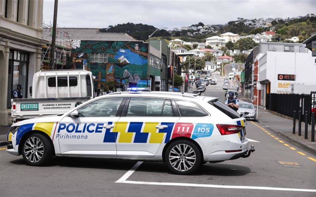 Armed police are at the edge of a cordon on Hopper Street in central Wellington on Wednesday.