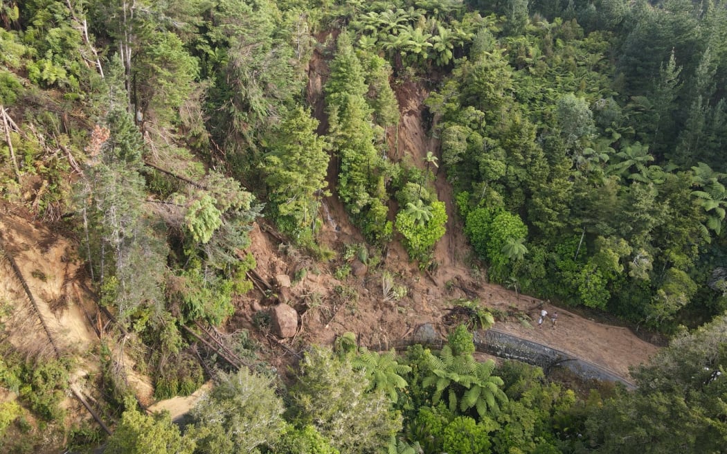 A drone image captures the massive slip at Helena Bay Hill in Northland, cutting off Ōakura Bay.