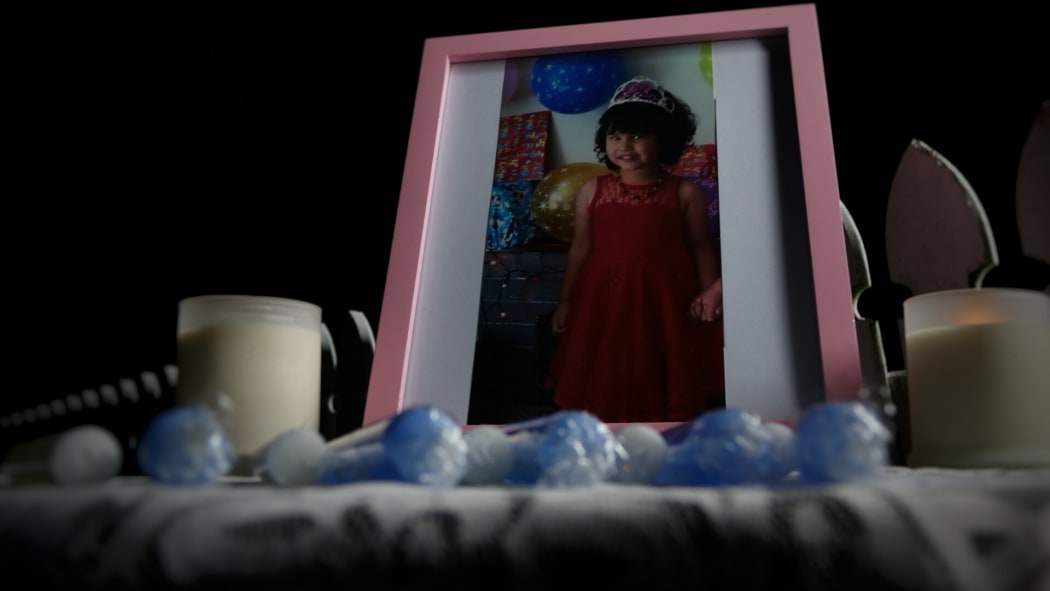 Candles, photos and flowers have been placed at the home where Maggie Renee Watson was found dead.